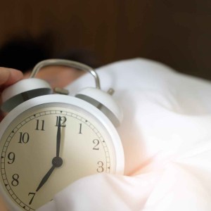 photo of person holding alarm clock